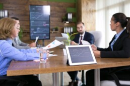 Business people reviewing consulting profitability metrics